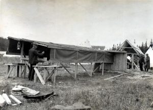 Black and white photograph of equipment for the 1905 solar eclipse in Labrador with people working