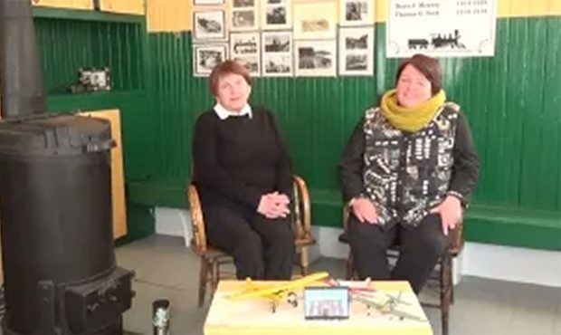 A coloured photo of Elaine and Pam Edwards sat in chairs during an interview.