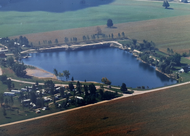 An aerial view of a lake lined with trees