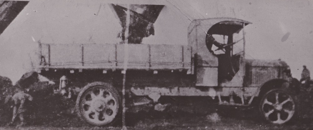 A black and white image of an old pick up truck with an open cab