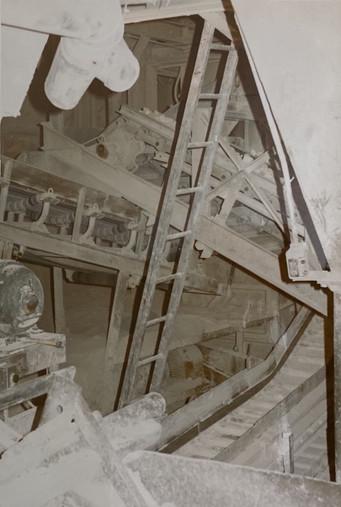 A twisted view of conveyors and ladders inside an industrial building