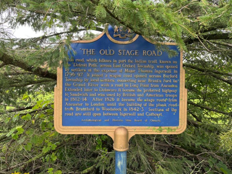 Gold and blue plaque describing significance of Old Stage Road