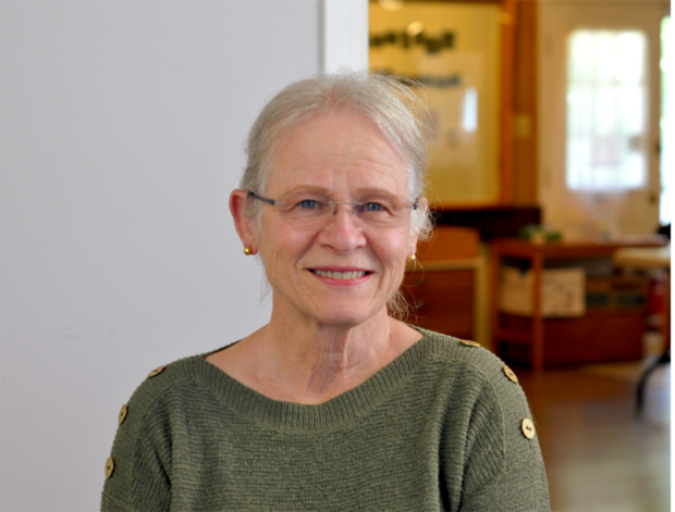 Colour photographic portrait of Dr. Christiane Deschenes. She has glasses and grey hair, and is wearing a green shirt.