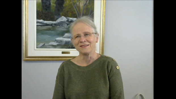 Colour photographic portrait of Dr. Christiane Deschenes. She has glasses and grey hair, and is wearing a green shirt.