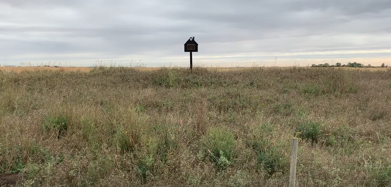 Sign in field marking former site of Silbernagel School, 1910-1948