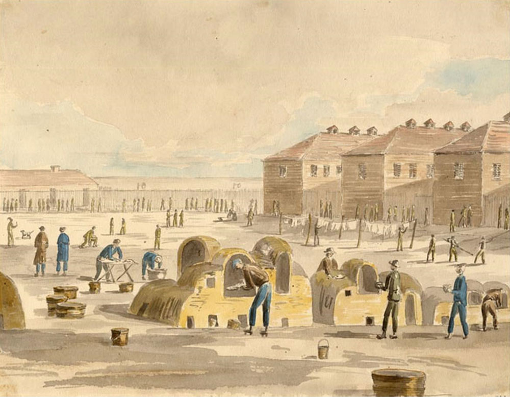 Three barracks buildings are at the back of the open square within the walls. On the square several prisoners are baking bread in outdoor ovens.