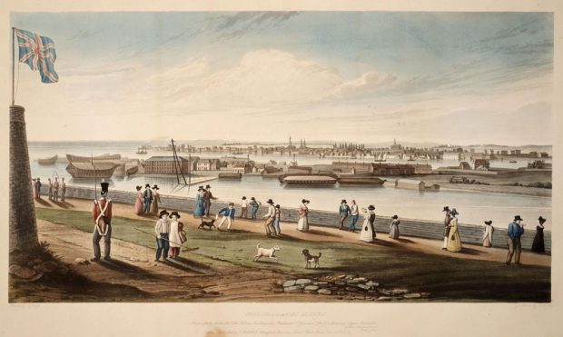 In a vintage coloured lithograph, at left, a Union Jack flies from a tower, overlooking Kingston, Ontario harbour. A redcoated soldier stands guard while people promenade beside the shore wall. Two dogs play with two children in the foreground. At the bottom is printed: Kingston from Fort Henry. Respectfully dedicated to his patrons, Sir Peregrine Maitland, Lt. Governor and the Gentlemen of Upper Canada by their obedient servt, James Gray. London, Published by Willett and Blanford, Bouverie Street Fleet Street Dec 7th 1828.