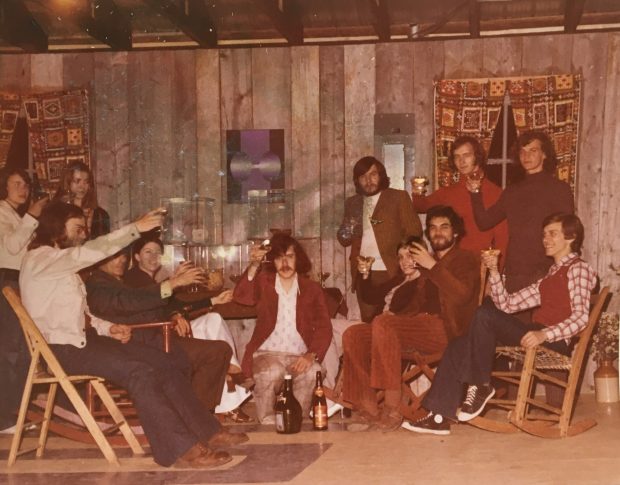 Twelve members of the museum team inside the Musée de Grondines raise a glass with a smile.