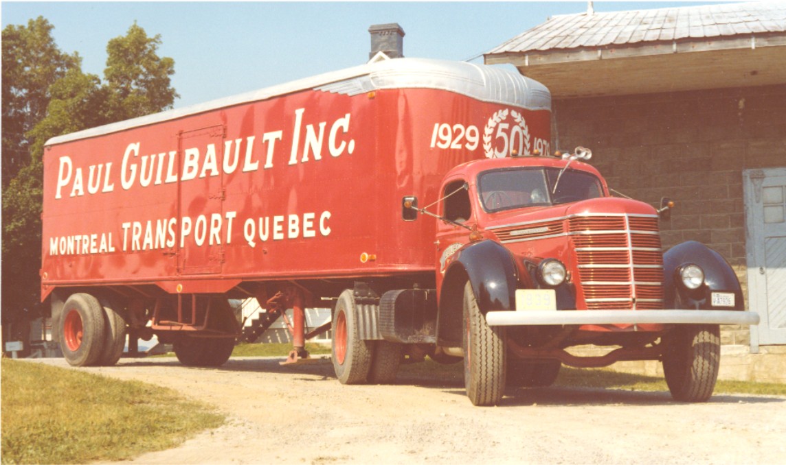 Photo of a red truck with the following inscription: “Paul Guilbault Inc. Montréal - Transport - Québec. 1929 - 50 - 1979 “.