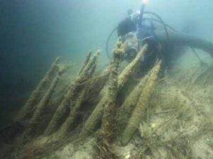 Underwater photograph of a diver observing the remaining wood structure of the Mnjikaning Fishing Weirs