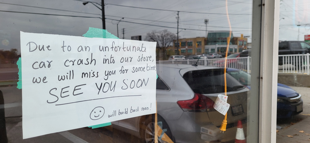 A handwritten sign on a window