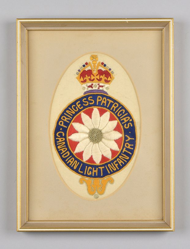 A framed colourful and detailed hand-embroidered Princess Patricia’s Canadian Light Infantry crest in an oval tan matte.