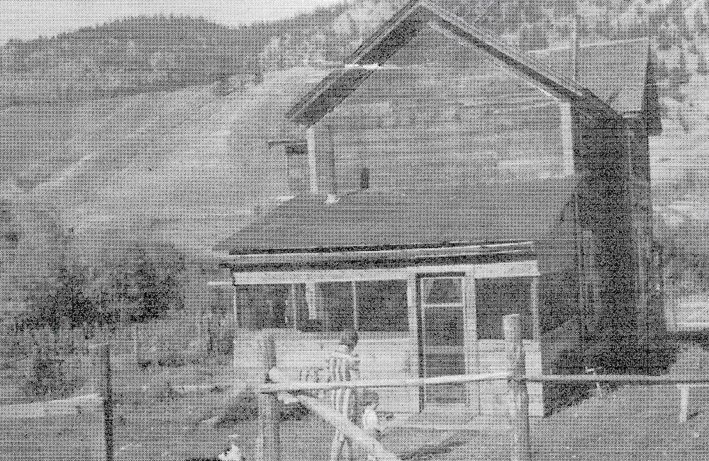 Woman and child walking to house before hill