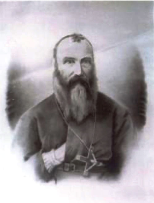 Head and shoulders photo of priest with hand in cassock