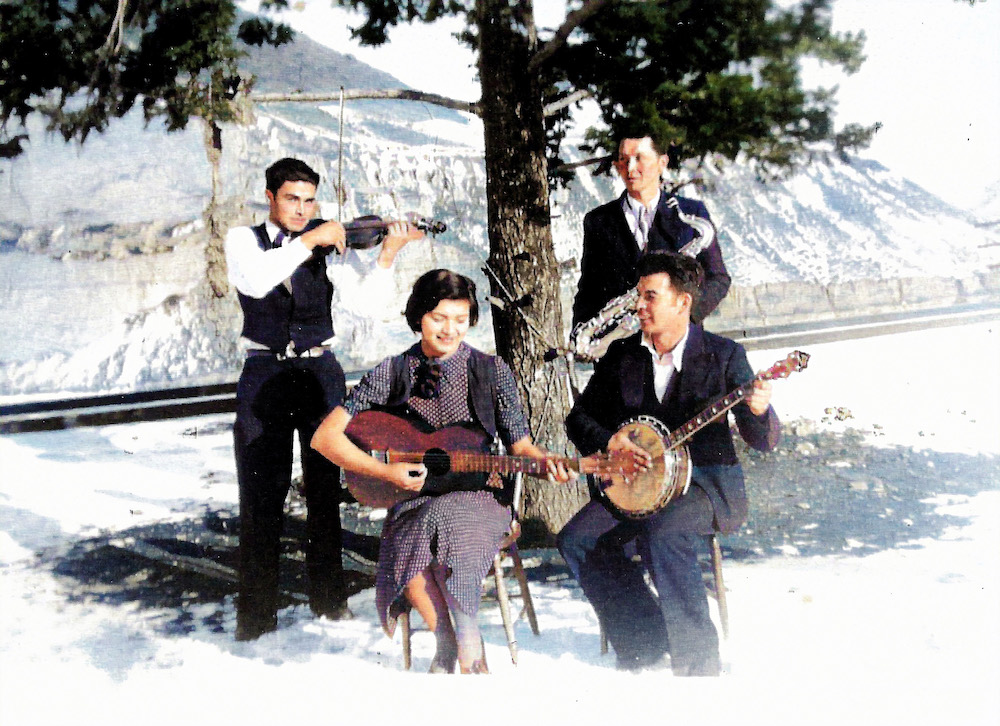 Four musicians performing outdoors during winter