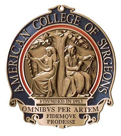 Color image representing a metallic seal mostly made of some sort of bronze. The central element is the depiction of the tree and the two seated men. Surrounding the center is inscribed American college of surgeons. At the bottom of the seal, it reads Founded in 1913 as well as the motto Omnibus per artem, fidemque, prodesse.