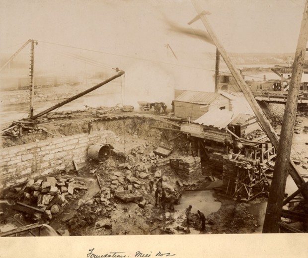 Mill No.2 construction site, foundation of stone mill. Cranes, stone structures, and rubble.