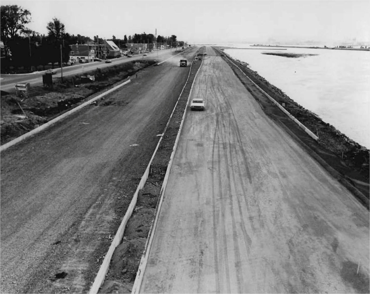 A highway with a suburb in the background