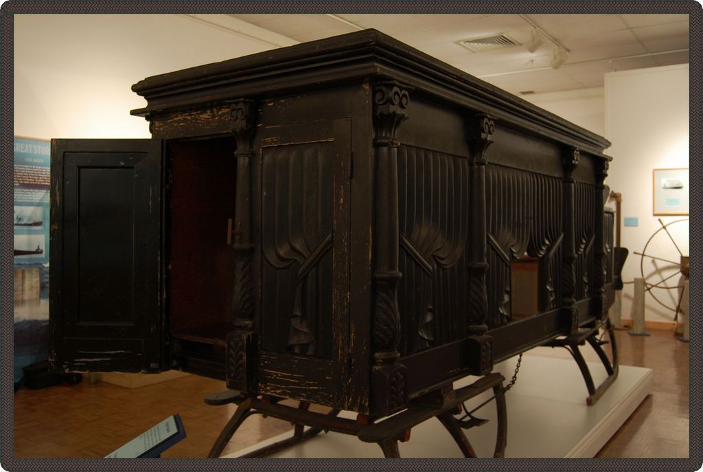 Back of hearse with two large wooden doors for sliding the body into the hearse.