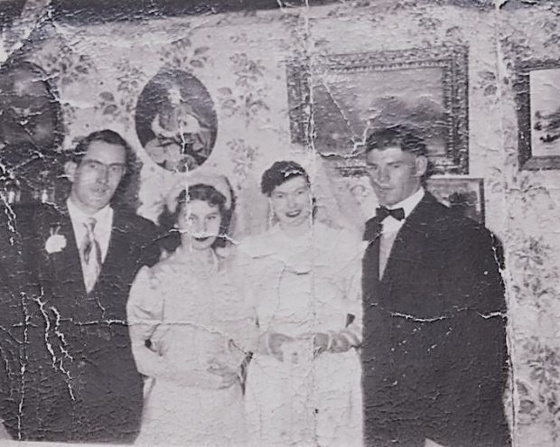 A bridal party poses for a picture in the groom's home