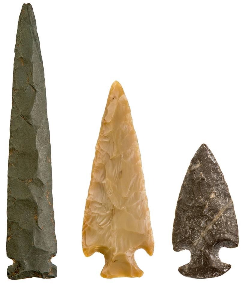 Three projectile points made of polished stone of various shapes.