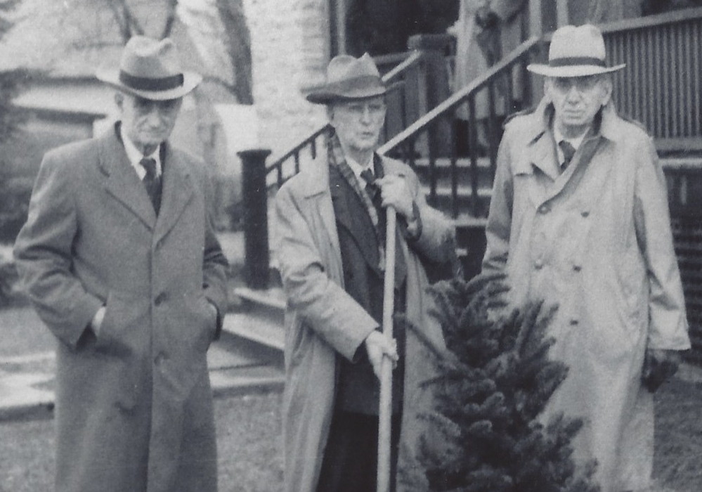 Black and white photograph of Dr. Dunn, Dr. Metcalfe and Dr. Kelly in front of the Rosamond Memorial Hospital during a tree planting ceremony on April 25, 1953.